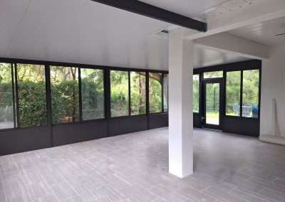 Extended patio and roof on this glass sunroom.