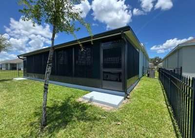 Screenroom Enclosure that includes a pet door on the left.
